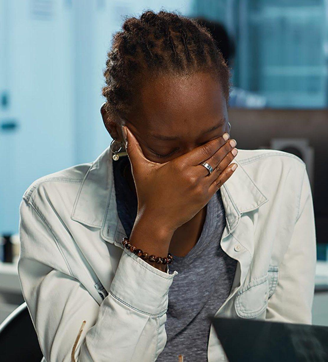 Woman covering her face in frustration